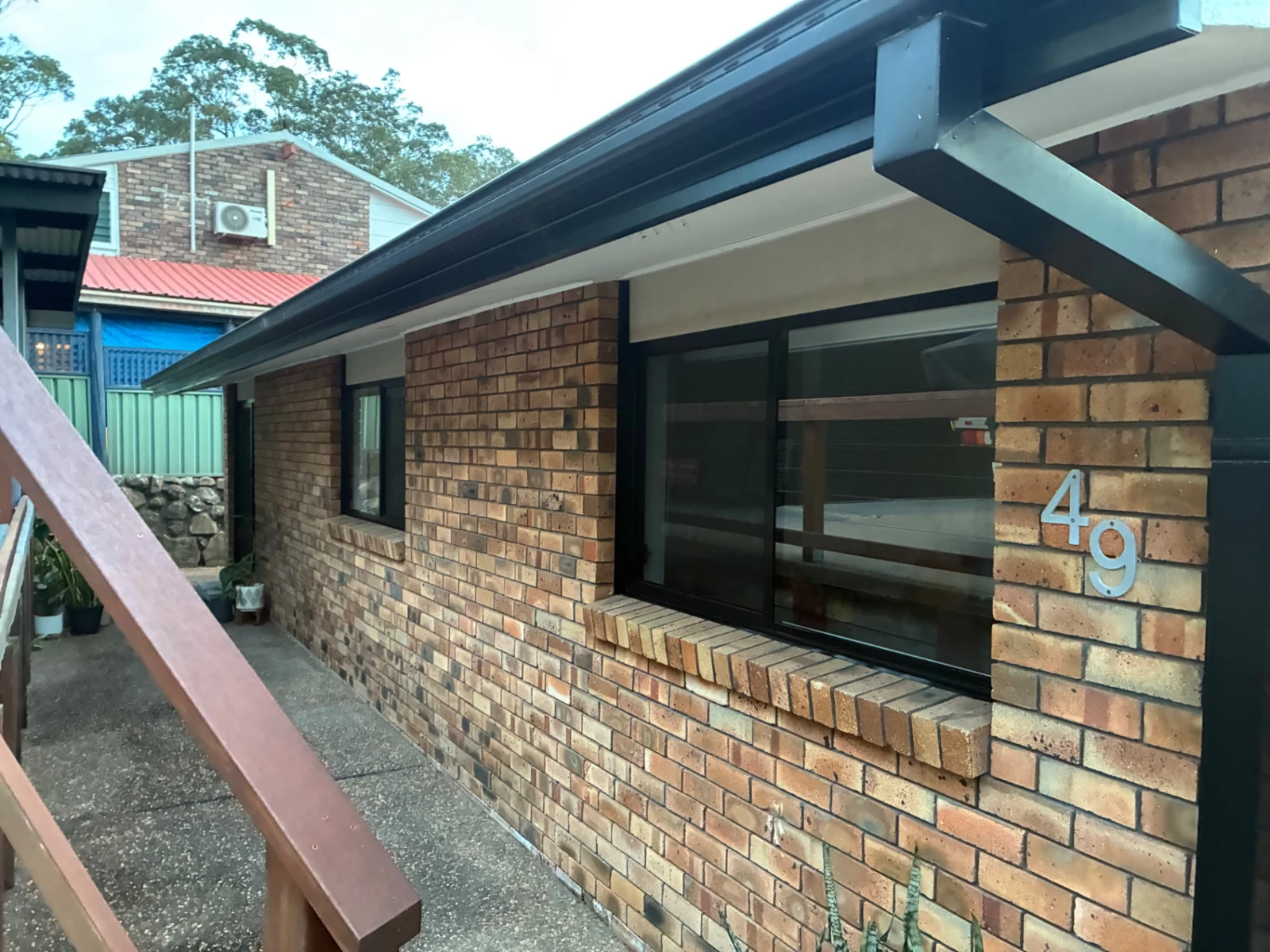 Black-framed exterior windows along a brick home