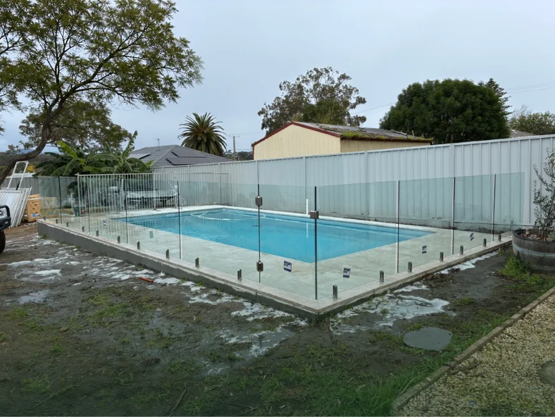 Frameless glass pool fencing installation by Pinnacle Glass & Timber around a new swimming pool