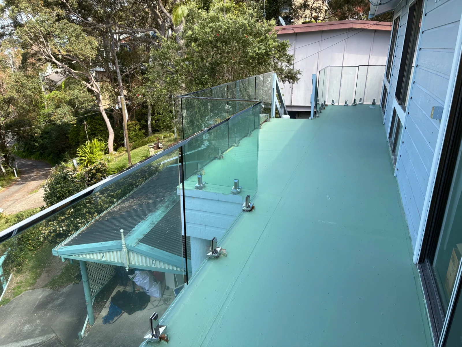 Frameless glass pool fencing with stainless-steel fittings and water views